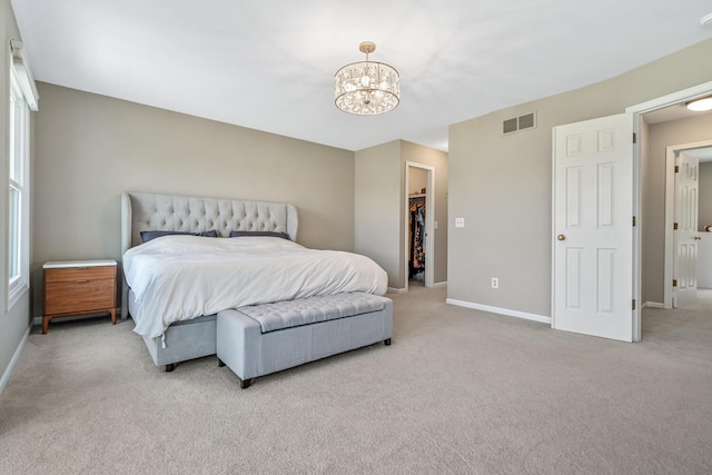 7639 Dunross Dr, Portage, MI 49024 - bedroom featuring light carpet, a chandelier, and a walk in closet