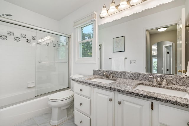 7639 Dunross Dr, Portage, MI 49024 - bathroom featuring double vanity, marble look tiles, and shower / bath combination with glass door