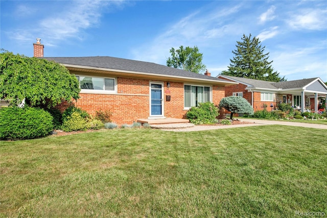 2491 Pinetree Dr, Trenton, MI 48183 - ranch-style home with a chimney, brick siding, and a front lawn
