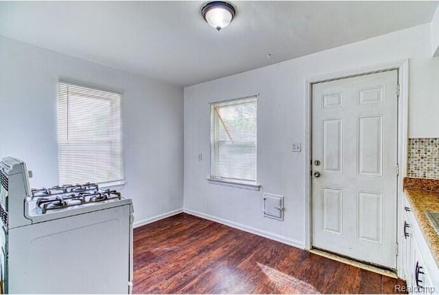 17710 Chester St, Detroit, MI 48224 - kitchen featuring white gas range, dark wood-style flooring, and white cabinetry