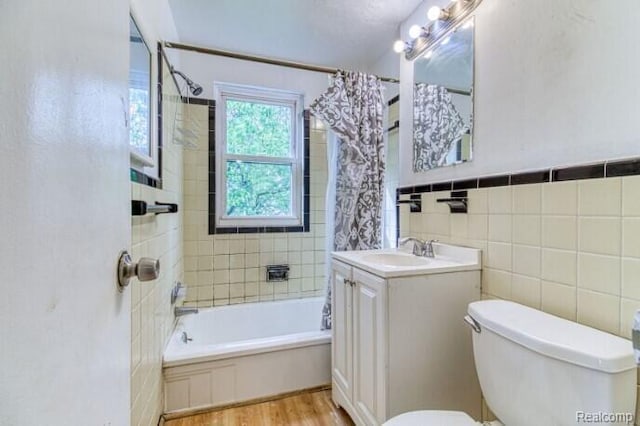 17710 Chester St, Detroit, MI 48224 - bathroom featuring shower / bath combo, wood finished floors, vanity, and tile walls