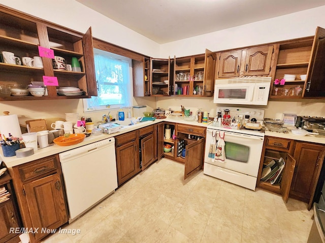 504 Abingdon St, Chesaning, MI 48616 - kitchen featuring open shelves, white appliances, and light countertops