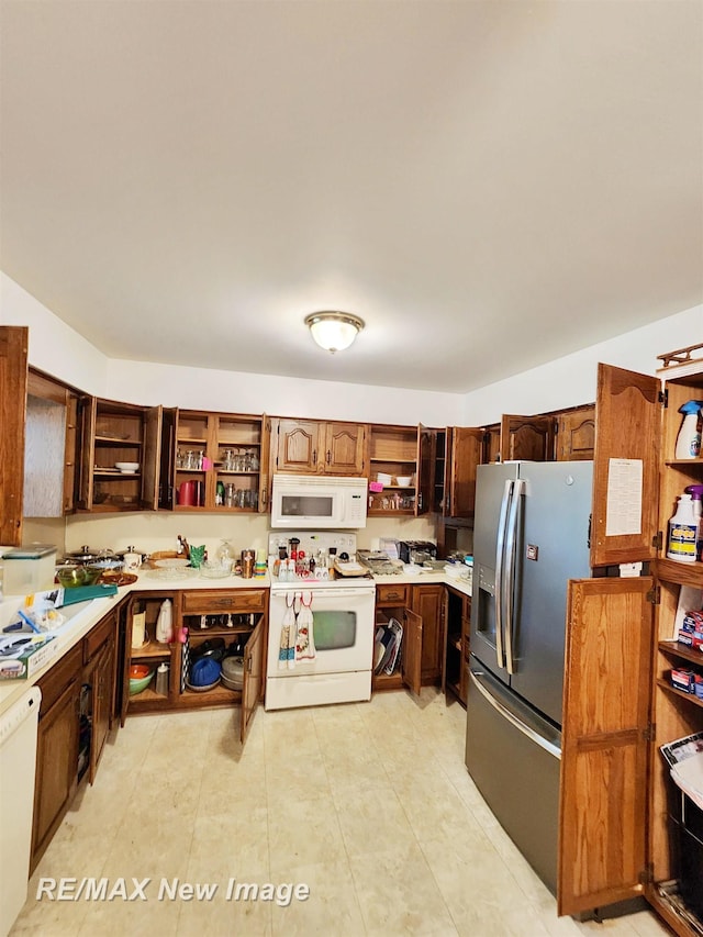 504 Abingdon St, Chesaning, MI 48616 - kitchen featuring open shelves, white appliances, and light countertops