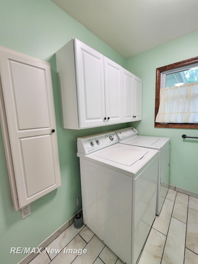 504 Abingdon St, Chesaning, MI 48616 - laundry area featuring washing machine and clothes dryer, cabinet space, and light tile patterned floors