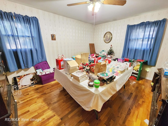 504 Abingdon St, Chesaning, MI 48616 - dining room featuring wood finished floors, ceiling fan, and wallpapered walls
