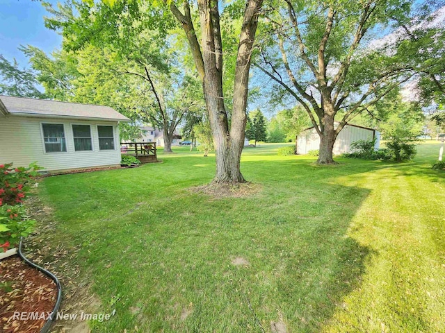 504 Abingdon St, Chesaning, MI 48616 - view of grassy yard with a deck