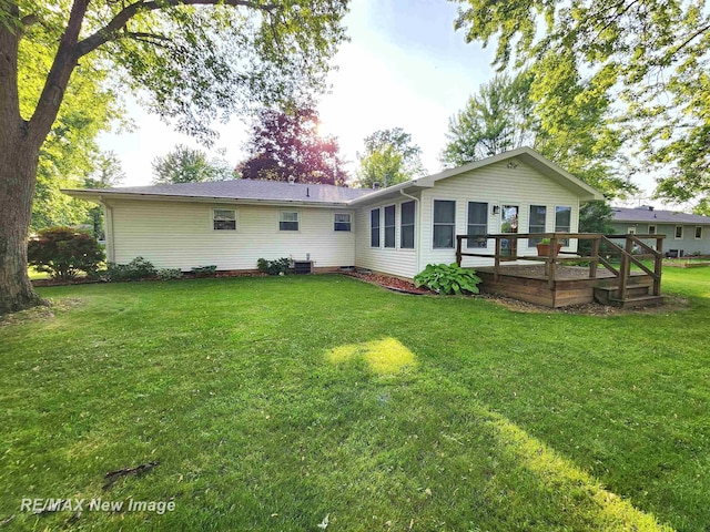 504 Abingdon St, Chesaning, MI 48616 - back of property featuring a lawn and a wooden deck