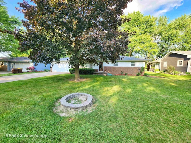 504 Abingdon St, Chesaning, MI 48616 - view of grassy yard with asphalt driveway and a garage