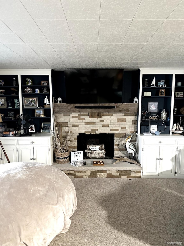 24579 US Highway 23 N, Ocqueoc, MI 49759 - bedroom featuring a fireplace and carpet floors