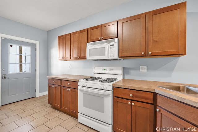 831 Bridge St NW, Grand Rapids, MI 49504 - kitchen with white appliances, brown cabinetry, and light countertops