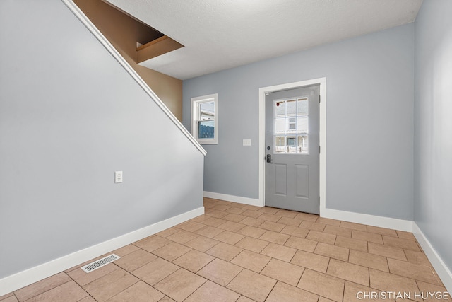 831 Bridge St NW, Grand Rapids, MI 49504 - foyer entrance with stairway and baseboards