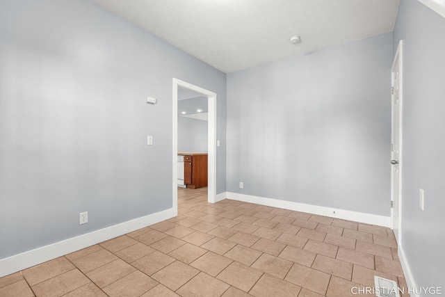 831 Bridge St NW, Grand Rapids, MI 49504 - unfurnished room featuring baseboards and a textured ceiling