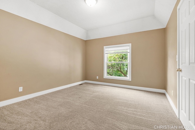 831 Bridge St NW, Grand Rapids, MI 49504 - unfurnished room with carpet and vaulted ceiling