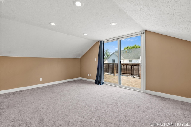 831 Bridge St NW, Grand Rapids, MI 49504 - bonus room with a textured ceiling, lofted ceiling, carpet floors, and recessed lighting