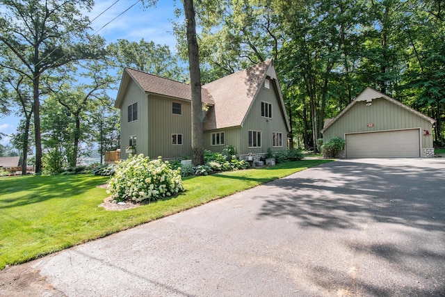 5254 Morrison St, Newaygo, MI 49337 - view of front of property featuring roof with shingles, an outdoor structure, a front lawn, and a garage