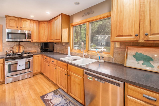 5254 Morrison St, Newaygo, MI 49337 - kitchen featuring stainless steel appliances, dark countertops, light wood-style floors, decorative backsplash, and recessed lighting