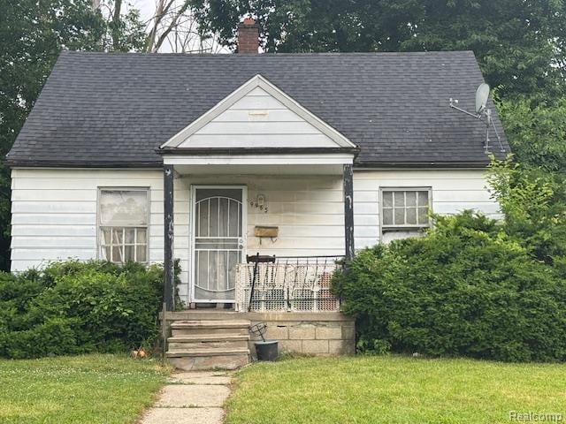 9965 Plainview Ave, Detroit, MI 48228 - view of front facade with a front lawn, a chimney, a porch, and roof with shingles