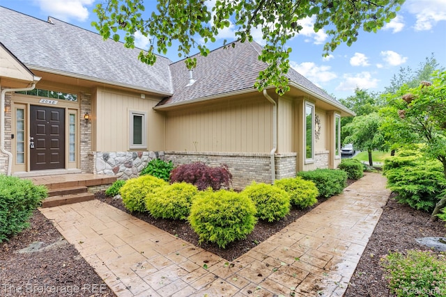 2048 Mayfair Dr, White Lake, MI 48383 - view of property exterior with roof with shingles and brick siding