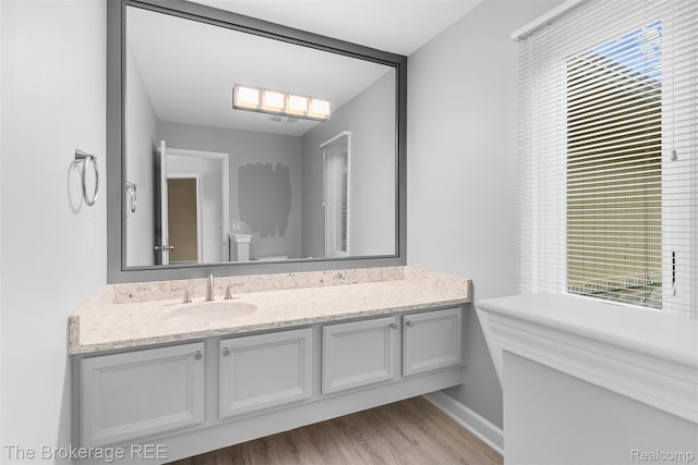 2048 Mayfair Dr, White Lake, MI 48383 - bathroom with vanity and wood finished floors