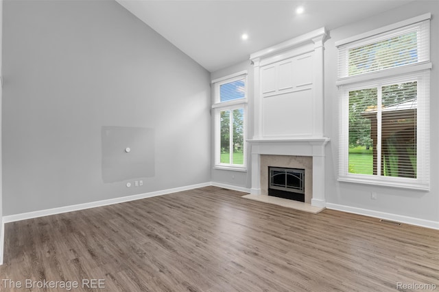 2048 Mayfair Dr, White Lake, MI 48383 - unfurnished living room featuring wood finished floors, a fireplace, high vaulted ceiling, and recessed lighting