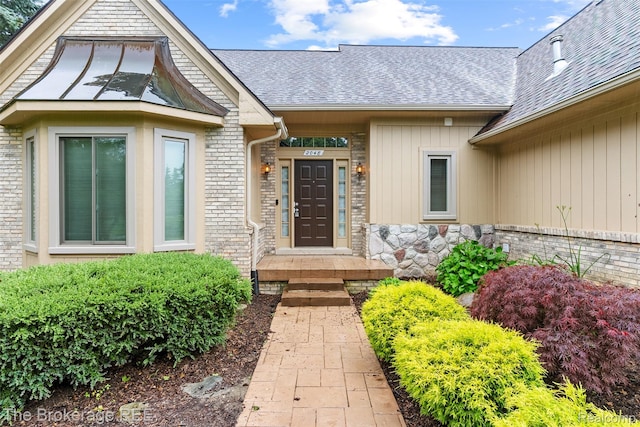 2048 Mayfair Dr, White Lake, MI 48383 - entrance to property with a shingled roof and stone siding