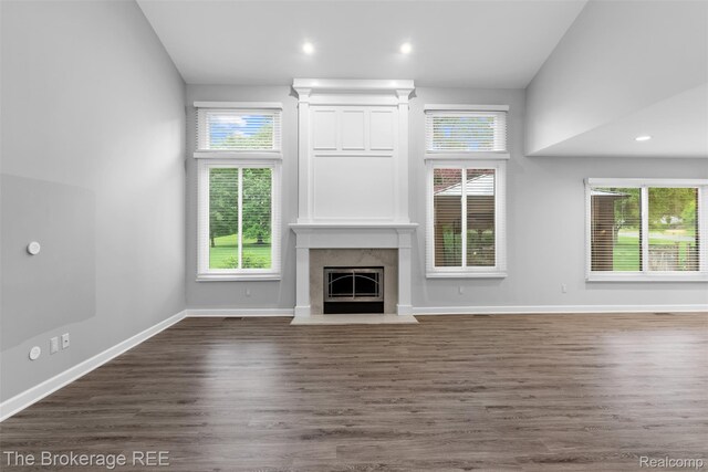 2048 Mayfair Dr, White Lake, MI 48383 - unfurnished living room with healthy amount of natural light, a high end fireplace, dark wood finished floors, and recessed lighting