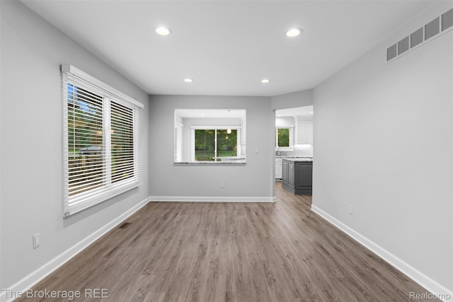 2048 Mayfair Dr, White Lake, MI 48383 - unfurnished living room with recessed lighting and wood finished floors