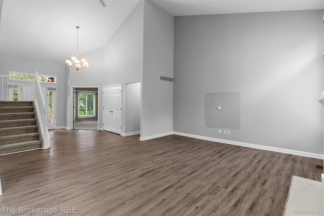 2048 Mayfair Dr, White Lake, MI 48383 - entryway featuring high vaulted ceiling, stairway, a chandelier, and wood finished floors