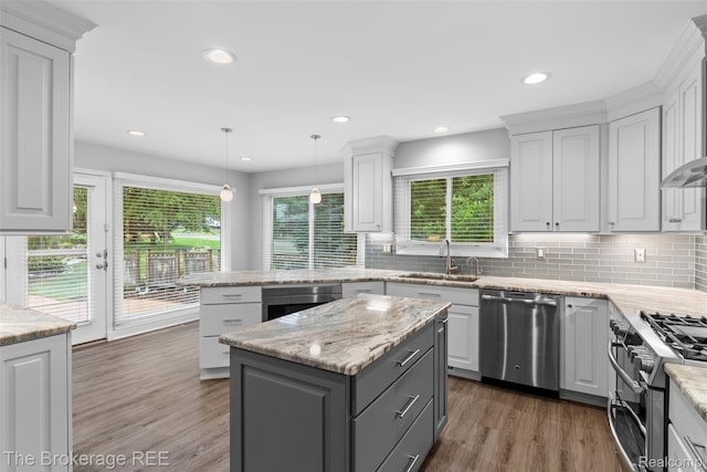 2048 Mayfair Dr, White Lake, MI 48383 - kitchen featuring stainless steel appliances, white cabinets, tasteful backsplash, plenty of natural light, and recessed lighting