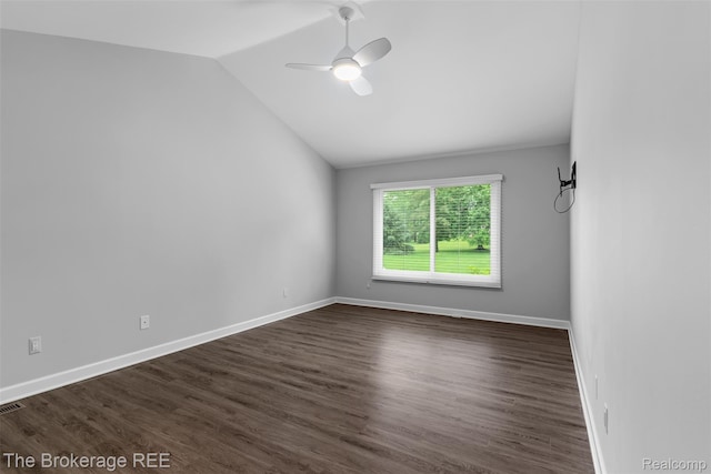 2048 Mayfair Dr, White Lake, MI 48383 - spare room with vaulted ceiling, a ceiling fan, and dark wood-type flooring