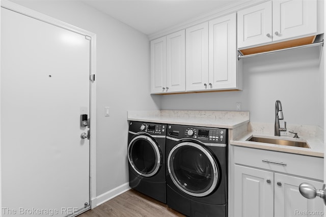 2048 Mayfair Dr, White Lake, MI 48383 - laundry room with separate washer and dryer, cabinet space, and light wood-style floors
