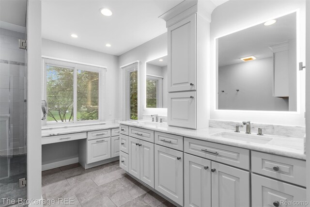 2048 Mayfair Dr, White Lake, MI 48383 - bathroom with double vanity, a stall shower, and recessed lighting
