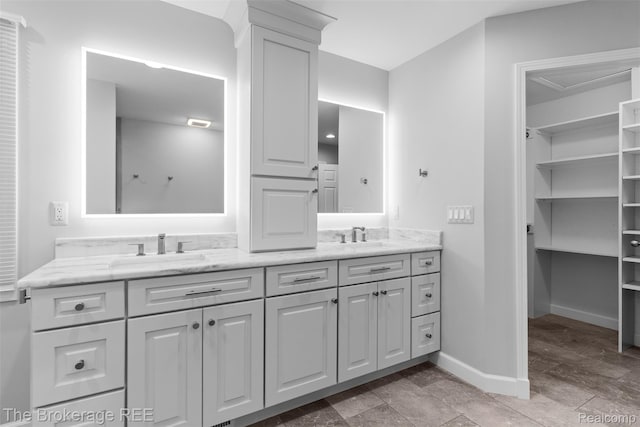 2048 Mayfair Dr, White Lake, MI 48383 - bathroom featuring double vanity and baseboards