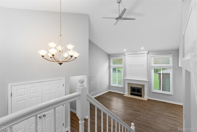 2048 Mayfair Dr, White Lake, MI 48383 - staircase with a high end fireplace, plenty of natural light, a chandelier, wood finished floors, and high vaulted ceiling