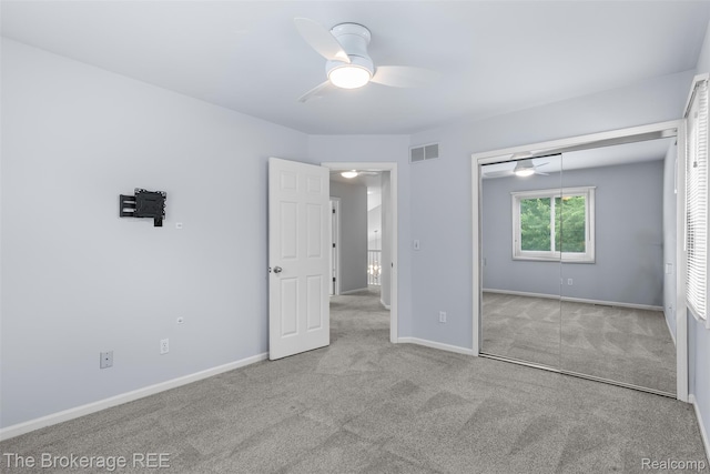 2048 Mayfair Dr, White Lake, MI 48383 - unfurnished bedroom with carpet floors, a closet, and a ceiling fan