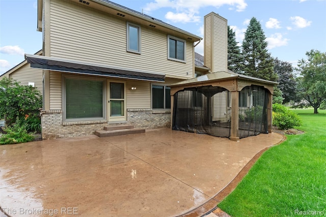 2048 Mayfair Dr, White Lake, MI 48383 - back of house with a gazebo, a patio area, a chimney, and brick siding