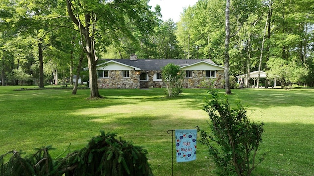 5724 E Townline Rd, Birch Run, MI 48415 - ranch-style house featuring a chimney, stone siding, and a front lawn