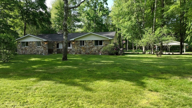 5724 E Townline Rd, Birch Run, MI 48415 - view of front of home with stone siding, a front lawn, and a gazebo