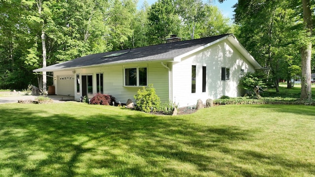 5724 E Townline Rd, Birch Run, MI 48415 - view of front of house with a chimney, a garage, and a front yard