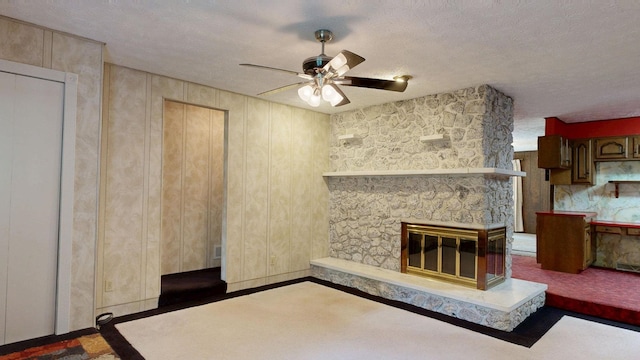 5724 E Townline Rd, Birch Run, MI 48415 - unfurnished living room with ceiling fan, a textured ceiling, and a fireplace