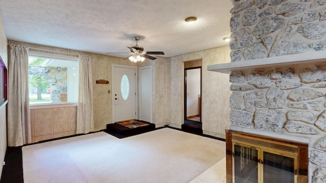 5724 E Townline Rd, Birch Run, MI 48415 - carpeted foyer with ceiling fan, a fireplace, and a textured ceiling