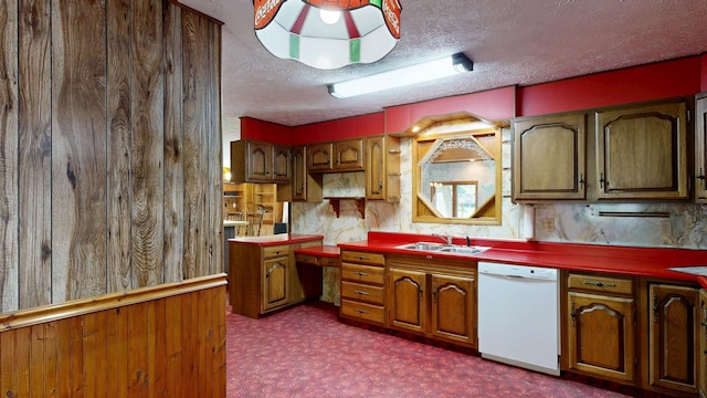 5724 E Townline Rd, Birch Run, MI 48415 - kitchen featuring dishwasher, dark colored carpet, a textured ceiling, and brown cabinets