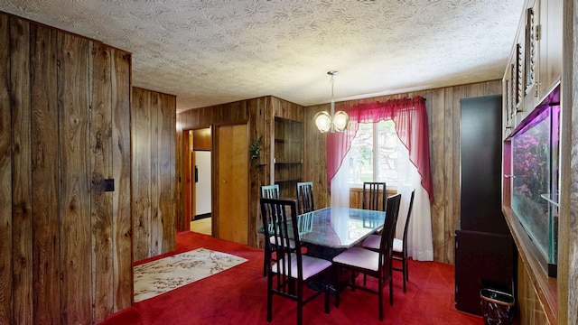 5724 E Townline Rd, Birch Run, MI 48415 - carpeted dining area with wood walls, a chandelier, and a textured ceiling