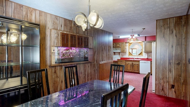 5724 E Townline Rd, Birch Run, MI 48415 - dining area featuring a chandelier, wooden walls, carpet floors, and a textured ceiling