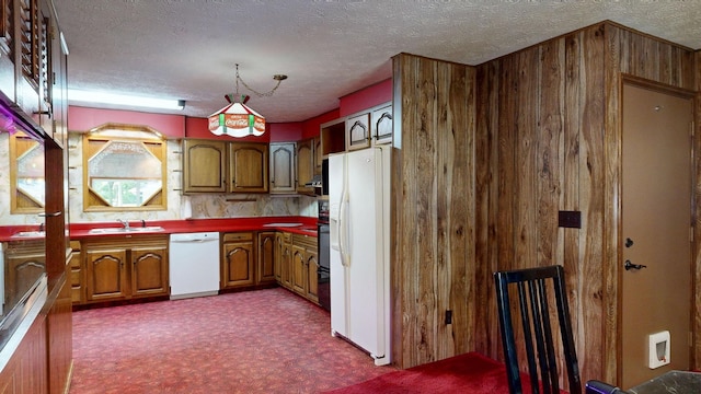 5724 E Townline Rd, Birch Run, MI 48415 - kitchen featuring white appliances, dark colored carpet, wood walls, brown cabinetry, and a textured ceiling