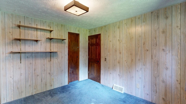 5724 E Townline Rd, Birch Run, MI 48415 - carpeted empty room featuring wood walls and a textured ceiling