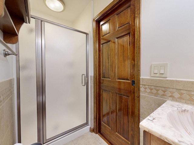 5724 E Townline Rd, Birch Run, MI 48415 - full bathroom featuring tile walls, tile patterned floors, a stall shower, and wainscoting