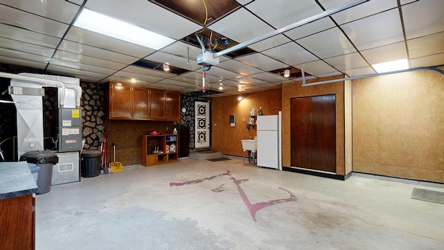 5724 E Townline Rd, Birch Run, MI 48415 - garage featuring freestanding refrigerator and a garage door opener