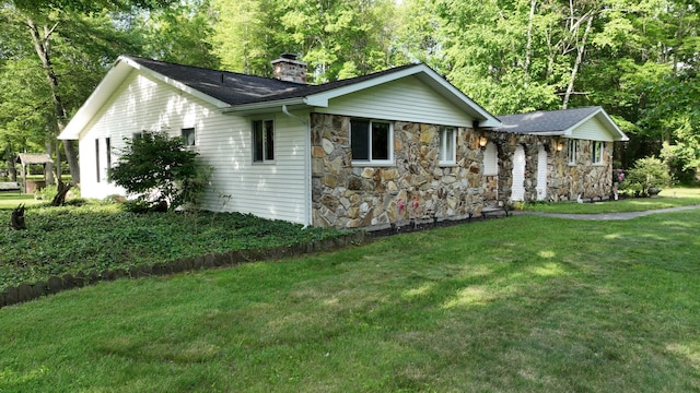 5724 E Townline Rd, Birch Run, MI 48415 - view of front of home with a chimney, a front yard, and stone siding