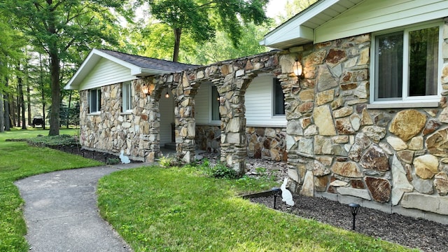 5724 E Townline Rd, Birch Run, MI 48415 - view of side of property with stone siding, a yard, and covered porch